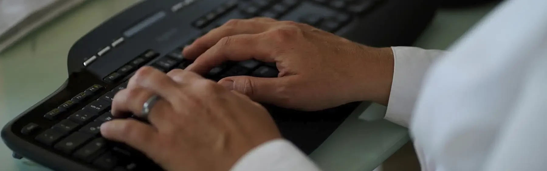 Stefanie Flunkert tippt auf ihrer Tastatur am Bürotisch