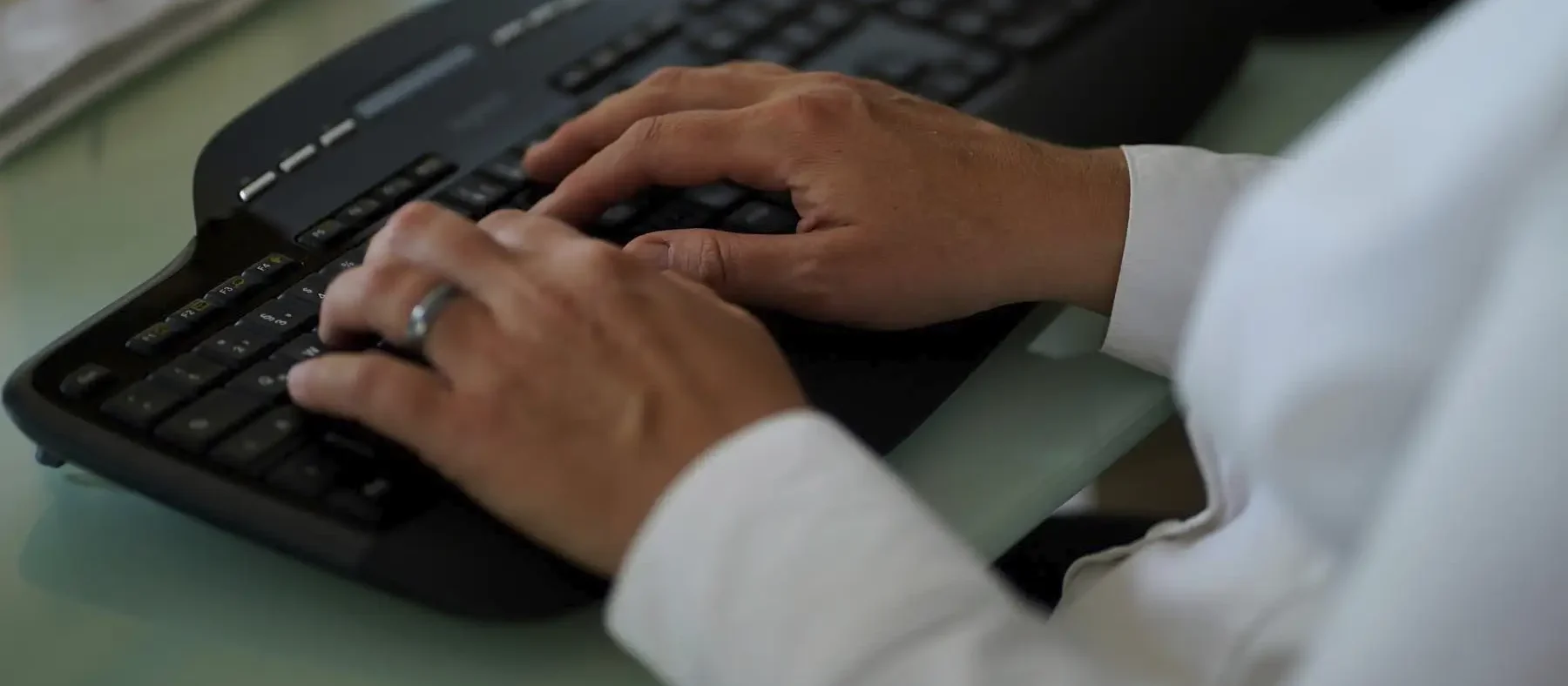 Stefanie Flunkert tippt auf ihrer Tastatur am Bürotisch