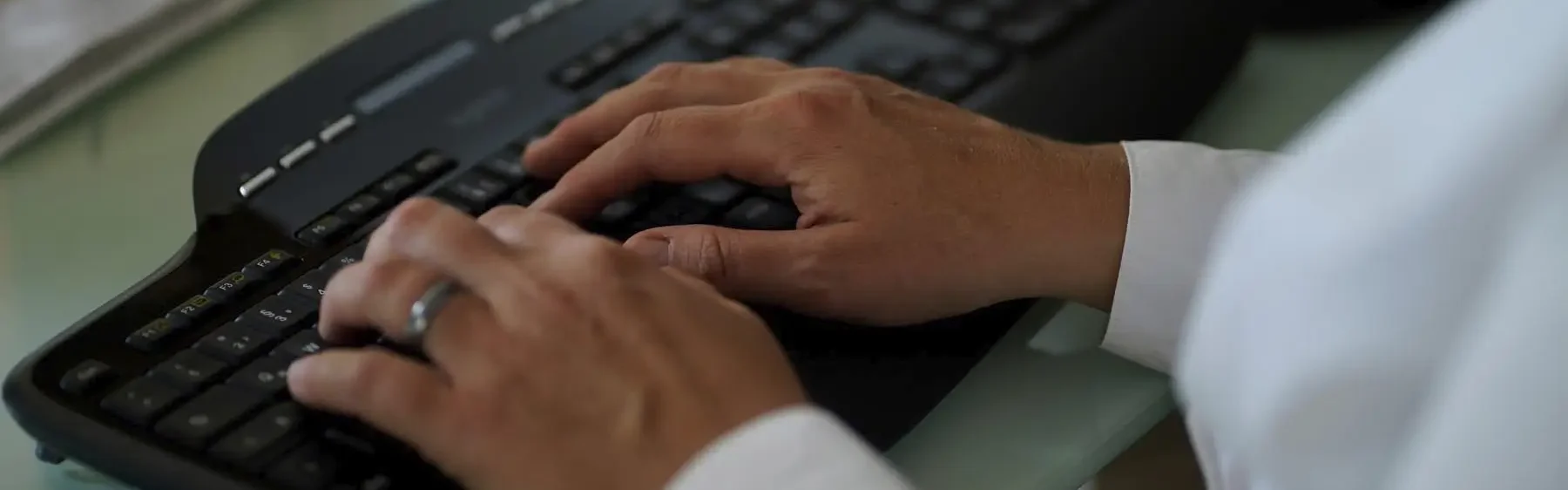 Stefanie Flunkert types on her keyboard at her office desk