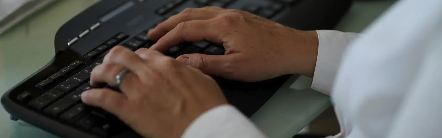 Stefanie Flunkert types on her keyboard at her office desk