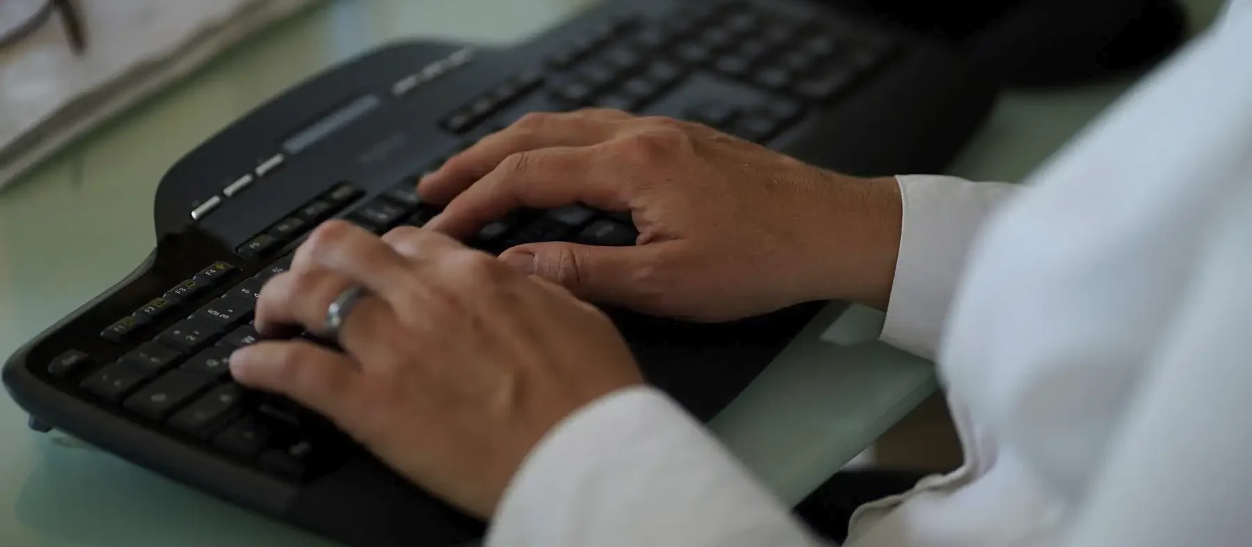 Stefanie Flunkert types on her keyboard at her office desk