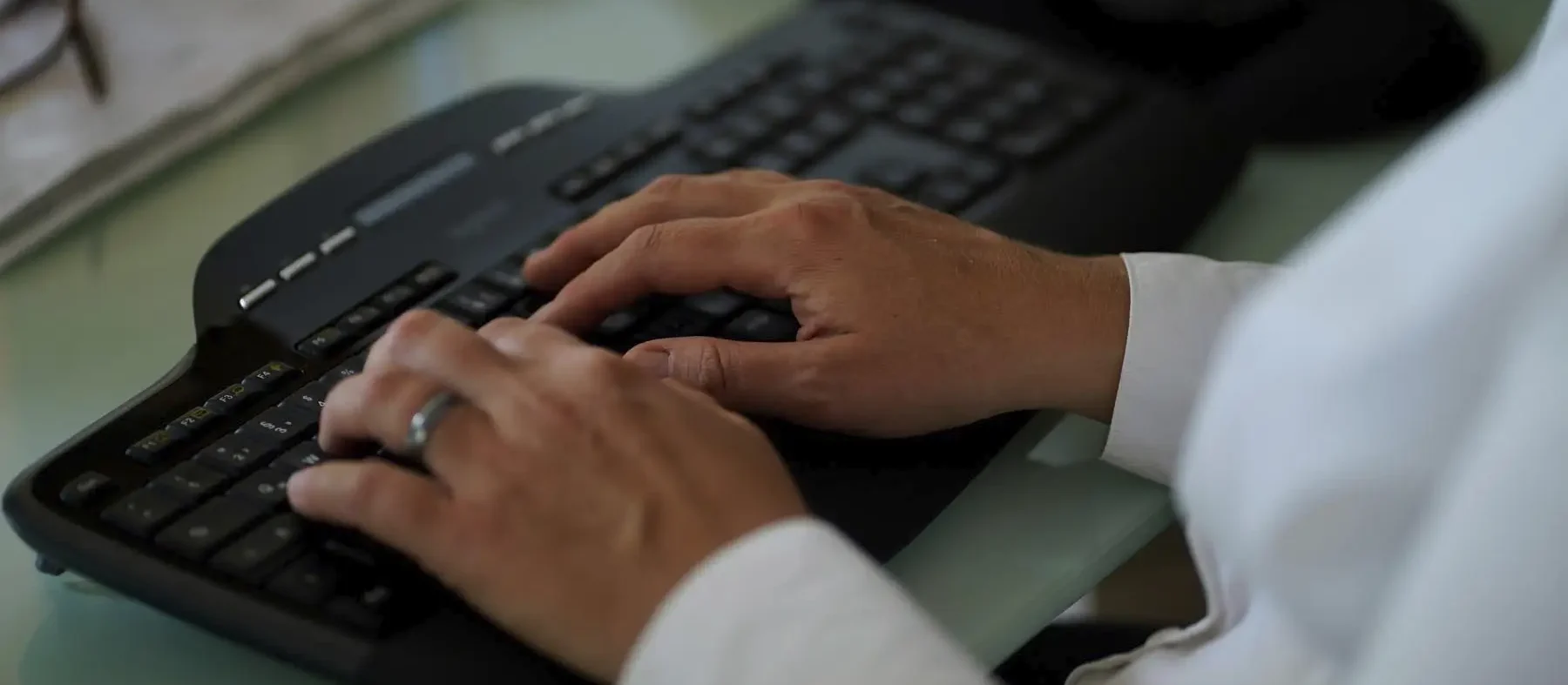 Stefanie Flunkert types on her keyboard at her office desk