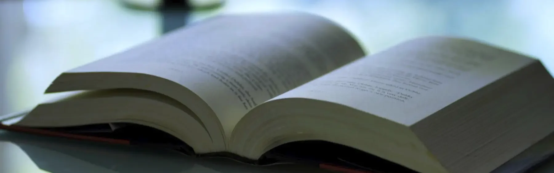 Open book with publications on a table