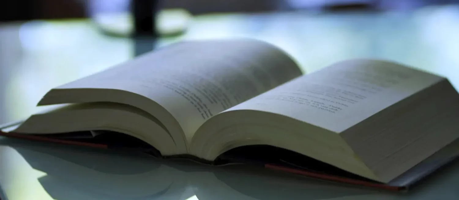 Open book with publications on a table