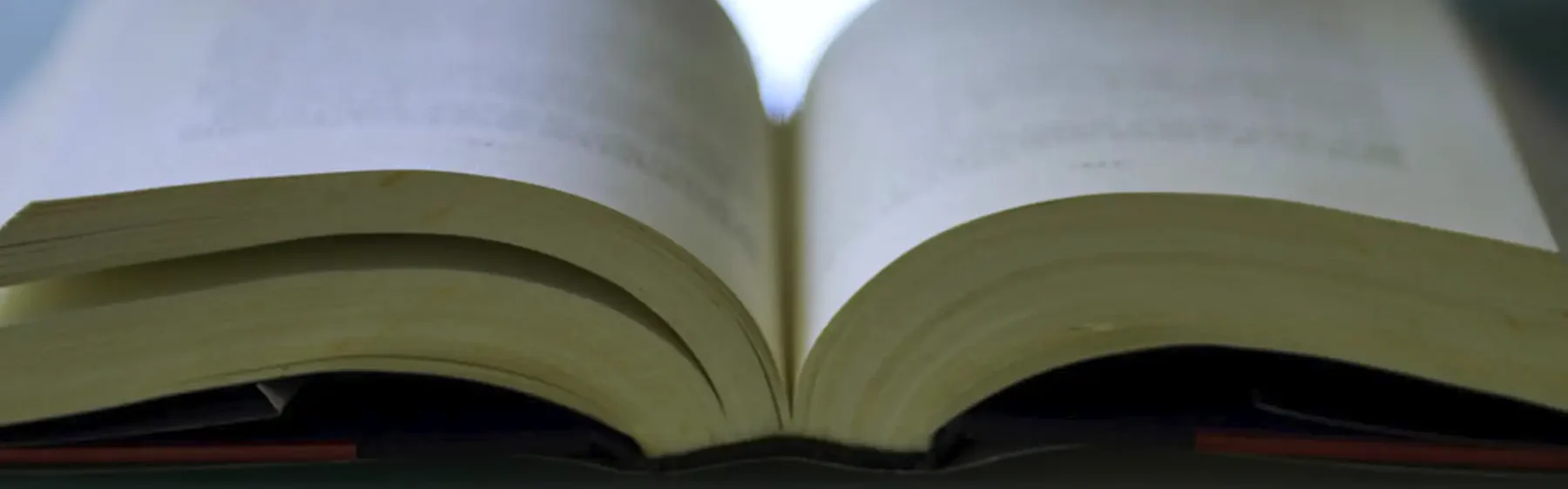 Open book with publications on a table