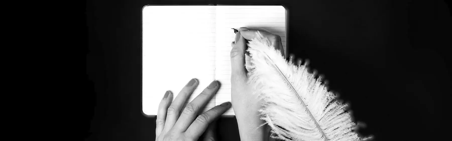 young woman writing in notebook with quil